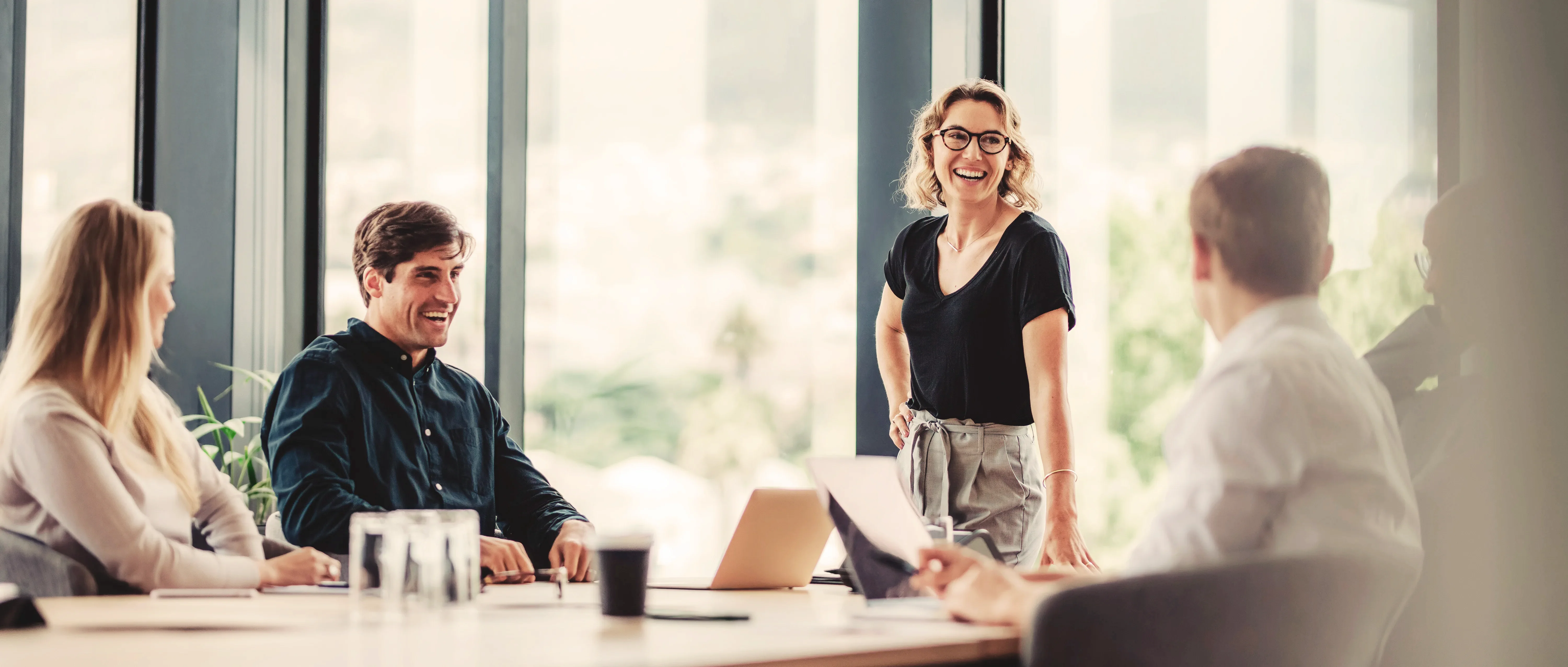 Mehrere Personen sitzen gemeinsam in einer hellen Büroumgebung an einem Tisch und führen ein Gespräch. Das Bild wird als Header der Seite Initiativbewerbung bei GARANT Immobilien verwendet und steht für Bewerbung, persönlichen Austausch und berufliche Chancen in der Immobilienbranche.